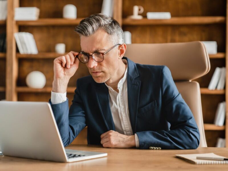 Man looking at computer in a fancy office