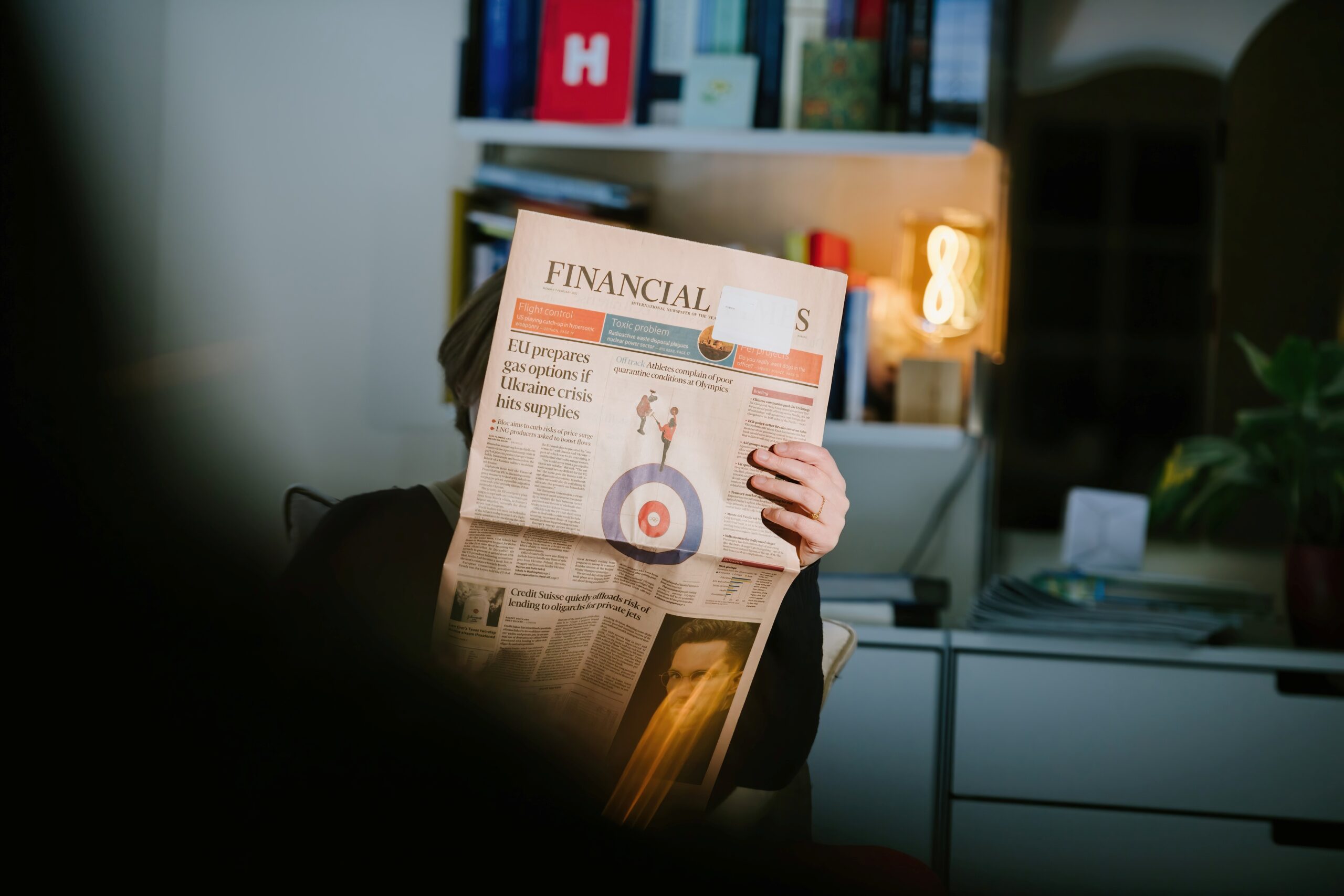 Person reading newspaper broadsheet